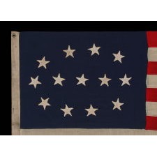 13 STAR FLAG WITH AN ELLIPTICAL MEDALLION OF HAND-SEWN STARS THAT FEATURES A ROW OF THREE IN THE CENTER, A DESIGN IDENTIFIED ON JUST FOUR SURVIVING ANTIQUE FLAGS; CIVIL WAR - CENTENNIAL ERA (1861-1876)