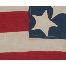 13 WHIMSICAL STARS IN A TALL AND NARROW CANTON, ON A HOMEMADE FLAG WITH OUTSTANDING FOLK PRESENTATION, MADE AROUND THE TIME OF THE 1876 CENTENNIAL
