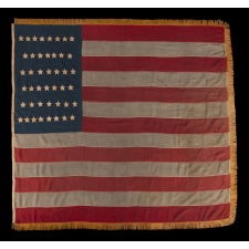 44 STARS ON AN ANTIQUE AMERICAN FLAG WITH AN EXAGGERATEDLY TALL AND NARROW CANTON, ON A U.S. ARMY REGULATION BATTLE FLAG MADE DURING THE LATE INDIAN WARS PERIOD, REFLECTS THE RECENT ADDITION OF WYOMING TO THE UNION, 1890-1896