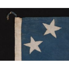 34 STARS ON A CORNFLOWER BLUE CANTON, ARRANGED IN A BEAUTIFUL VARIANT OF THE "GREAT STAR" PATTERN, ON AN ENTIRELY HAND-SEWN ANTIQUE AMERICAN MADE DURING THE OPENING YEARS OF THE CIVIL WAR, 1861-63, IN AN EXTREMELY SMALL AND DESIRABLE SCALE FOR THE PERIOD