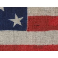 33 STAR ANTIQUE AMERICAN FLAG WITH A DOUBLE WREATH STAR CONFIGURATION, PRESS-DYED ON WOOL BUNTING, PROBABLY MADE FOR MILITARY USE AS CAMP COLORS OR A GUIDON, ONE-OF-A-KIND AMONG KNOWN EXAMPLES, WEST VIRGINIA STATEHOOD, 1863-1865