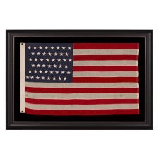 46 STAR ANTIQUE AMERICAN FLAG IN AN EXCEPTIONALLY SMALL SCALE AMONG ITS PIECED-AND-SEWN COUNTERPARTS, REFLECTS OKLAHOMA STATEHOOD, CIRCA 1907-1912:
