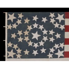 43 STAR ANTIQUE AMERICAN FLAG REFLECTING IDAHO STATEHOOD, ONE OF THE RAREST STAR COUNTS AMONG SURVIVING AMERICAN FLAGS OF THE 19TH CENTURY; A MASTERPIECE OF EARLY FLAG-MAKING WITH AN EXCEPTIONAL STARBURST MEDALLION CONFIGURATION, CIRCA 1890