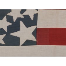 43 STAR ANTIQUE AMERICAN FLAG REFLECTING IDAHO STATEHOOD, ONE OF THE RAREST STAR COUNTS AMONG SURVIVING AMERICAN FLAGS OF THE 19TH CENTURY; A MASTERPIECE OF EARLY FLAG-MAKING WITH AN EXCEPTIONAL STARBURST MEDALLION CONFIGURATION, CIRCA 1890