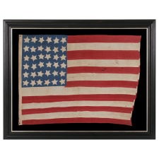 ANTIQUE AMERICAN FLAG WITH 36 STARS ON A CORNFLOWER BLUE CANTON, CIVIL WAR ERA, 1864-1867, REFLECTS THE ADDITION OF NEVADA AS THE 36TH STATE; A GREAT FOLK EXAMPLE WITH HAPHAZARD ROWS OF STARFISH-LIKE STARS