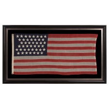 44 STARS IN ZIGZAGGING ROWS ON A SMALL SCALE ANTIQUE AMERICAN FLAG WITH AN ATTRACTIVE, ELONGATED PROFILE, WYOMING STATEHOOD, 1890-1896
