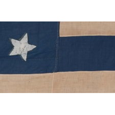 28 STAR ANTIQUE AMERICAN FLAG, REFLECTS THE ADDITION OF TEXAS TO THE UNION AS THE 28TH STATE IN 1845, ONE OF THE RAREST STAR COUNTS IN AMERICAN HISTORY, WITH THE EXCEPTIONALLY UNUSUAL PRESENCE OF RED, WHITE, AND BLUE STRIPES, ALMOST NEVER ENCOUNTERED ON SURVIVING EXAMPLES; OFFICIAL FOR JUST ONE YEAR (1845-46)