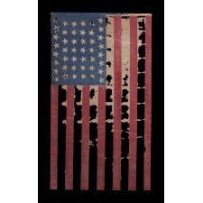44 TUMBLING STARS IN AN HOURGLASS PATTERN, ON AN ANTIQUE AMERICAN FLAG WITH A GHOSTLY PRESENTATION FROM EXTENSIVE WEAR, REFLECTS WYOMING STATEHOOD, 1890-1896