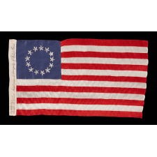 13 HAND-EMBROIDERED STARS AND EXPERTLY HAND-SEWN STRIPES ON AN ANTIQUE AMERICAN FLAG MADE IN PHILADELPHIA BY SARAH M. WILSON, GREAT-GRANDDAUGHTER OF BETSY ROSS, SIGNED & DATED 1911