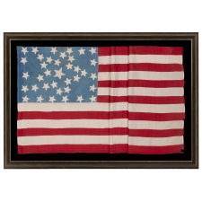 ANTIQUE AMERICAN FLAG WITH 37 STARS ON A CORNFLOWER BLUE CANTON, ARRANGED IN A UNIQUE “GREAT STAR” OR “GREAT LUMINARY” CONFIGURATION, INCORPORATED INTO A RECTANGULAR MEDALLION; A HOMEMADE EXAMPLE, MADE DURING THE ERA OF AMERICAN RECONSTRUCTION; REFLECTS NEBRASKA STATEHOOD, 1867-1876