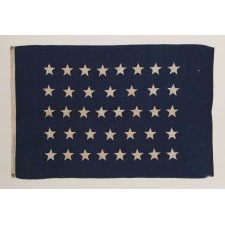 ANTIQUE AMERICAN U.S. NAVY JACK WITH 38 HAND-SEWN STARS AND A RARE MAKER'S MARK OF FLAG AND SAILMAKER W. K. HINMAN OF NEW YORK CITY, FLOWN ON THE YACHT "MARY EMMA," THE FIRST OF SUCH CRAFT OWNED BY AMERICAN FINANCIER AND THREE-TIME WINNER OF THE AMERICA'S CUP, C. OLIVER ISELIN; 1876-1877, REFLECTS COLORADO STATEHOOD