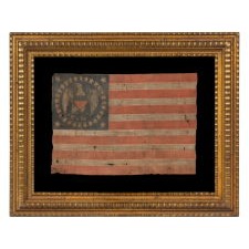 EXTRAORDINARILY RARE ANTIQUE AMERICAN FLAG, WITH A FEDERAL EAGLE SURROUNDED BY 32 STARS, THE ONLY KNOWN EXAMPLE OF ITS KIND; TWO OF THE STARS FAR SMALLER THAN THE REST, LIKELY TO REFLECT WESTERN TERRITORIES; MADE IN THE DECADE BEFORE, OR WITHIN THE PERIOD, WHEN MINNESOTA JOINED THE UNION AS THE 32nd STATE; A ONE-YEAR FLAG, ACCURATE FOR JUST NINE MONTHS, 1858-59