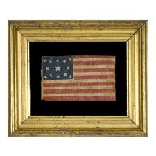13 STAR ANTIQUE AMERICAN FLAG, WITH A RARE, OVAL MEDALLION CONFIGURATION OF STARS, MADE SOMETIME BETWEEN THE CIVIL WAR (1861-65) AND THE 1876 CENTENNIAL OF AMERICAN INDEPENDENCE