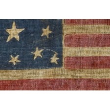 13 STAR ANTIQUE AMERICAN FLAG, WITH A RARE, OVAL MEDALLION CONFIGURATION OF STARS, MADE SOMETIME BETWEEN THE CIVIL WAR (1861-65) AND THE 1876 CENTENNIAL OF AMERICAN INDEPENDENCE