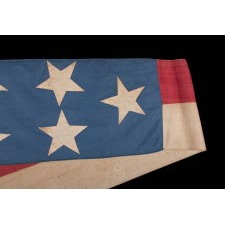 ENTIRELY HAND-SEWN SHIP’S COMMISSION PENNANT OF THE MID-19TH CENTURY, A HOMEMADE, COTTON EXAMPLE WITH 13 STARS ON A CORNFLOWER BLUE FIELD AND EXTREMELY DYNAMIC PRESENTATION