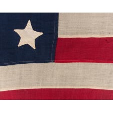 ANTIQUE AMERICAN FLAG WITH 20 STARS AND 13 STRIPES, PROBABLY A U.S. NAVY SMALL BOAT ENSIGN OF THE LATE CIVIL WAR ERA, MADE WHEN THERE WERE 20 FREE STATES