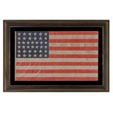 38 STAR ANTIQUE AMERICAN PARADE FLAG, IN AN ESPECIALLY LARGE SCALE AND WITH BOLD COLOR, MADE DURING THE PERIOD WHEN COLORADO WAS THE MOST RECENT STATE ADDED TO THE UNION, 1876-1889
