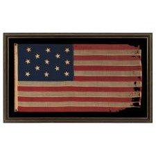 ANTIQUE AMERICAN FLAG WITH 13 HAND-SEWN STARS IN THE 3-2-3-2-3 PATTERN, A U.S. NAVY SMALL BOAT ENSIGN, MADE BETWEEN ROUGHLY 1870 – 1882, WITH ENDEARING WEAR FROM OBVIOUS USE