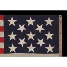 13 STARS IN A 3-2-3-2-3 PATTERN ON AN ANTIQUE AMERICAN FLAG, A UNITED STATES NAVY SMALL BOAT ENSIGN, MADE AT THE BROOKLYN NAVY YARD, NEW YORK, SIGNED & DATED 1912