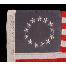 13 HAND-EMBROIDERED STARS AND EXPERTLY HAND-SEWN STRIPES ON AN ANTIQUE AMERICAN FLAG MADE IN PHILADELPHIA BY SARAH M. WILSON, GREAT-GRANDDAUGHTER OF BETSY ROSS, SIGNED & DATED 1911