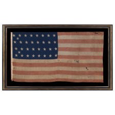 34 STAR ANTIQUE AMERICAN FLAG OF THE CIVIL WAR PERIOD (1861-63), WITH WOVEN STRIPES AND PRESS-DYED OR PRINTED STARS, POSSIBLY MADE IN NEW YORK BY THE ANNIN COMPANY, REFLECTS THE ADDITION OF KANSAS TO THE UNION, 1861-1863