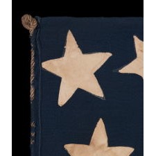 31 STARS ON AN EXTRAORDINARY ANTIQUE AMERICAN FLAG WITH A RANDOM CONSTELLATION, IN VARIOUS SHAPES AND SIZES, CLUSTERED ABOUT AN ENORMOUS CENTER STAR, WITH A COMPLIMENT OF 10 STRIPES; A MASTERPIECE OF EARLY AMERICAN FLAG-MAKING, CALIFORNIA STATEHOOD, 1850-1858