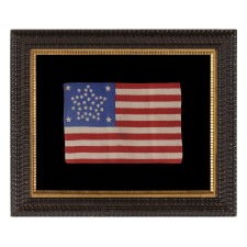 38 STAR FLAG WITH A RARE AND BEAUTIFUL VARIATION OF THE "GREAT STAR" PATTERN THAT FEATURES 4 OUTLIERS AND A STAR BETWEEN EACH ARM, EXCEPT IN ONE LOCATION, LEAVING ROOM FOR A 39TH TO BE ADDED; MADE IN THE PERIOD WHEN COLORADO WAS THE MOST RECENT STATE TO JOIN THE UNION, 1876-1889