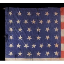 38 STARS WITH SCATTERED ORIENTATION, ON A SILK ANTIQUE AMERICAN PARADE FLAG WITH GENEROUS SCALE AND ENDEARING WEAR FROM OBVIOUS USE, COLORADO STATEHOOD, 1876-1889
