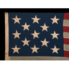 ENTIRELY HAND-SEWN, 13 STAR AMERICAN FLAG, A U.S. NAVY SMALL BOAT ENSIGN MARKED “No. 12,” WITH A 3-2-3-2-3 ARRANGEMENT OF ESPECIALLY LARGE AND ATTRACTIVE STARS, LIKELY MADE DURING THE CLOSING YEARS OF THE CIVIL WAR, 1864-1865