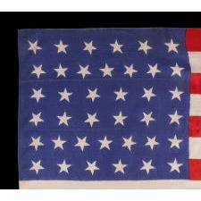 38 STAR ANTIQUE AMERICAN PARADE FLAG WITH SCATTERED STAR ORIENTATION, MADE OF SILK, WITH GENEROUS SCALE AND VIVID COLORS, COLORADO STATEHOOD, 1876-1889
