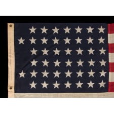 44 STARS IN AN INTERESTING, NOTCHED CONFIGURATION, ON AN ANTIQUE AMERICAN FLAG MADE BY THE U.S. BUNTING COMPANY IN LOWELL, MASSACHUSETTS, REFLECTS THE ERA WHEN WYOMING WAS THE MOST RECENT STATE TO JOIN THE UNION, 1890-1896