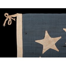 WAR-PERIOD CONFEDERATE FLAG IN THE FIRST NATIONAL PATTERN (a.k.a., STARS & BARS), WITH WREATH OF 7 STARS, IN A TINY SCALE AMONG ITS COUNTERPARTS, PROBABLY MADE FOR USE AS A MILITARY FLANK MARKER OR CAMP COLORS, CIRCA 1861