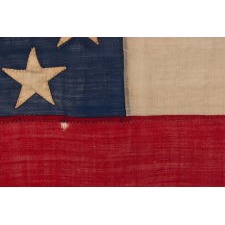 WAR-PERIOD CONFEDERATE FLAG IN THE FIRST NATIONAL PATTERN (a.k.a., STARS & BARS) WITH A CRUDE WREATH OF 7 STARS, IN A SMALL SCALE AMONG ITS COUNTERPARTS, PROBABLY MADE FOR USE AS A MILITARY FLANK MARKER OR CAMP COLORS, CIRCA 1861