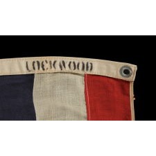 FLAG OF THE UNITED STATES TERRITORY OF HAWAII, THAT WOULD EVENTUALLY BECOME THE FLAG OF THE STATE; EXHIBITS AN UNUSUAL VARIANT OF THE BRITISH UNION FLAG AND GREAT COLORS, MADE circa 1900-1915, SIGNED “LOCKWOOD”
