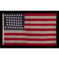44 STAR ANTIQUE AMERICAN FLAG WITH AN HOURGLASS ARRANGEMENT ON A TWO-TONE BLUE CANTON; REFLECTS THE ERA WHEN WYOMING WAS THE MOST RECENT STATE TO JOIN THE UNION, 1890-1896