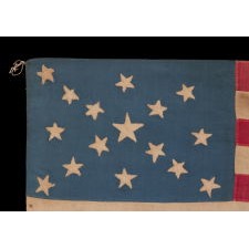 16 STARS IN A RARE AND BEAUTIFUL STARBURST MEDALLION THAT FEATURES A DISTINCT SALTIRE; A HOMEMADE AND ENTIRELY HAND-SEWN, ANTIQUE AMERICAN FLAG, MADE WITH AN ABOLITIONIST MESSAGE BY REMOVING THE SLAVE STATES FROM THE STAR COUNT, circa 1850-1858, YET WITH A COMBINATION OF TRAITS AND FEATURES THAT CURIOUSLY REFLECT TENNESSEE AS THE 16TH STATE TO JOIN THE UNION AND THE 11TH STATE TO LEAVE