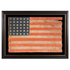 36 STAR ANTIQUE AMERICAN PARADE FLAG OF THE CIVIL WAR ERA, IN AN ESPECIALLY LARGE SCALE, WITH BOLD COLOR, AND ENDEARING WEAR FROM EXTENDED USE, 1864-67, NEVADA STATEHOOD