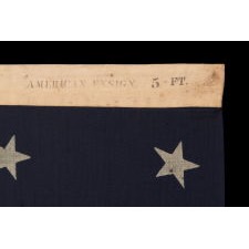 38 STAR ANTIQUE AMERICAN FLAG WITH A NOTCHED CONFIGURATION, MADE BY THE U.S. BUNTING COMPANY IN LOWELL, MASSACHUSETTS, SIGNED "THROCKMORTON," REFLECTS THE ERA OF COLORADO STATEHOOD, CIRCA 1876-1889