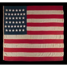 38 STAR ANTIQUE AMERICAN FLAG OF THE INDIAN WARS PERIOD, A U.S. ARMY REGULATION BATTLE FLAG, ENTIRELY HAND-SEWN, 1876-1889, SIGNED "VARRELL." MADE IN THE ERA WHEN COLORADO WAS THE MOST RECENT STATE TO JOIN THE UNION