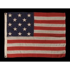 13 STAR ANTIQUE AMERICAN FLAG WITH A 3-2-3-2-3 CONFIGURATION OF STARS AND STRONG PRESENTATION, WITH RICH COLORS AND SQUARISH PROPORTIONS, MADE CIRCA 1895-1926; EXHIBITED AT THE MUSEUM OF THE AMERICAN REVOLUTION, JUNE-JULY 2019