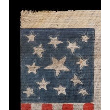 13 STAR ANTIQUE AMERICAN PARADE FLAG, MADE BETWEEN THE CIVIL WAR (1861-65) AND THE 1876 CENTENNIAL OF AMERICAN INDEPENDENCE, FEATURING THREE SIZES OF WHIMSICALLY SHAPED STARS IN A MEDALLION CONFIGURATION