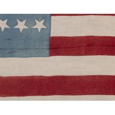 38 STAR ANTIQUE AMERICAN PARADE FLAG IN A SQUARE, BATTLE FLAG STYLE, PRINTED ON SILK, WITH BEAUTIFUL CORNFLOWER BLUE AND SCARLET RED COLORATION; POSSIBLY SOLD AS A KERCHIEF / BANDANNA; UNIQUE AMONG KNOWN EXAMPLES, PROBABLY MADE FOR THE 1888 CAMPAIGN OF BENJAMIN HARRISON; REFLECTS COLORADO STATEHOOD, 1876-1889