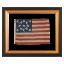 13 HALOED STARS IN A MEDALLION CONFIGURATION, ON AN EXCEPTIONALLY RARE ANTIQUE AMERICAN FLAG MADE FOR THE 1876 CENTENNIAL OF AMERICAN INDEPENDENCE