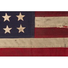 AMERICAN FLAG WITH 48 STARS, A U.S. NAVY SMALL BOAT ENSIGN FROM A WWII SUBMARINE, WITH ENDEARING WEAR FROM LONG-TERM USE; THE FLAG MADE IN JANUARY, 1944 AT MARE ISLAND, CALIFORNIA; BROUGHT HOME BY GUNNER’S MATE 2ND CLASS, JAY J. BURKINS OF LANCASTER COUNTY, PENNSYLVANIA