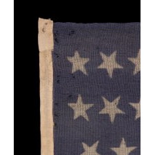 34 STARS WITH "DANCING" OR "TUMBLING" ORIENTATION, ON AN ANTIQUE AMERICAN FLAG WITH EXTRAORDINARY COLORS, PRESS-DYED ON WOOL BUNTING, LIKELY PRODUCED FOR USE AS MILITARY CAMP COLORS, CIVIL WAR PERIOD, 1861-1863, REFLECTS THE ADDITION OF KANSAS TO THE UNION AS A FREE STATE