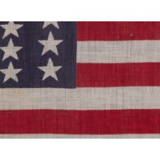 39 STARS IN TWO SIZES, ALTERNATING FROM ONE COLUMN TO THE NEXT, ON AN ANTIQUE AMERICAN PARADE FLAG WITH AN UNUSUALLY ELONGATED PROFILE, DATING TO THE 1876 CENTENNIAL, NEVER AN OFFICIAL STAR COUNT, REFLECTS THE ANTICIPATED ARRIVAL OF COLORADO AND THE DAKOTA