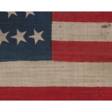 38 CRUDE STARS IN VARIOUS SIZES, ON A CLAMP-DYED, WOOL, ANTIQUE AMERICAN FLAG, MADE BY THE HORSTMANN BROTHERS IN PHILADELPHIA, ALMOST CERTAINLY FOR DISPLAY AT THE 1876 CENTENNIAL EXPOSITION; A VERY RARE AND ENDEARINGLY VISUAL EXAMPLE, REFLECTS COLORADO STATEHOOD