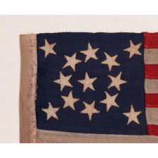 13 STAR ANTIQUE AMERICAN FLAG WITH A MEDALLION CONFIGURATION OF STARS; A TINY EXAMPLE AMONG ITS COUNTERPARTS WITH SEWN CONSTRUCTION, MADE circa 1895-1926, EXHIBITED AT THE MUSEUM OF THE AMERICAN REVOLUTION, JUNE-JULY 2019