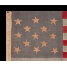 13 STAR ANTIQUE AMERICAN FLAG, WITH A 3-2-3-2-3 CONFIGURATION OF STARS ON A BEAUTIFUL, DUSTY BLUE CANTON, A SMALL-SCALE EXAMPLE OF THE LATE 19TH CENTURY