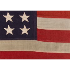 ANTIQUE AMERICAN FLAG WITH 48 STARS, A U.S. NAVY SMALL BOAT ENSIGN, MADE IN JUNE OF 1943, DURING WWII, AT MARE ISLAND, CALIFORNIA, HEADQUARTERS OF THE PACIFIC FLEET, WITH ENDEARING WEAR FROM OBVIOUS LONG-TERM USE
